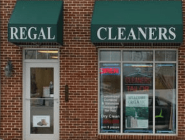 Regal Cleaners storefront in Woodbridge, VA — green awnings with brick facade